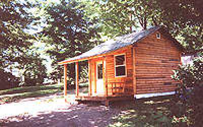 A two-room cabin with 4 built in bunks, and a living room/dinning room/full kitchen combination, and a covered porch.