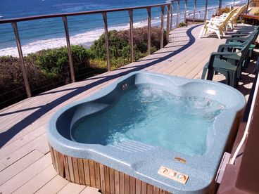 The deck railing curves along the front jacuzzi and patio deck