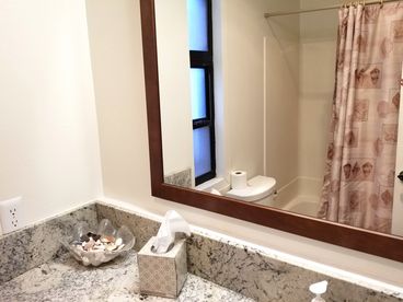 Your bathroom on the first floor has a full tub, upgraded vanity. You step through the laundry room to this bathroom